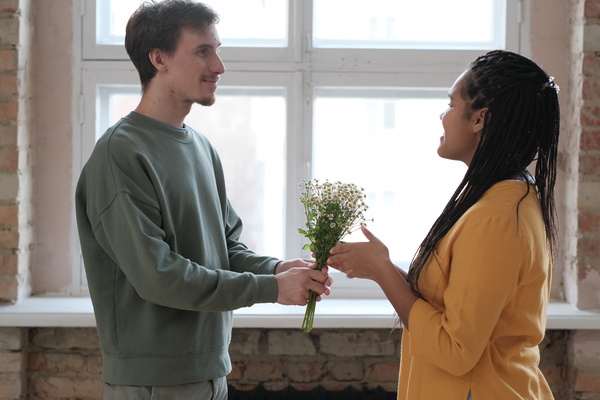 Man Gives Chamomile Bouquet to Woman